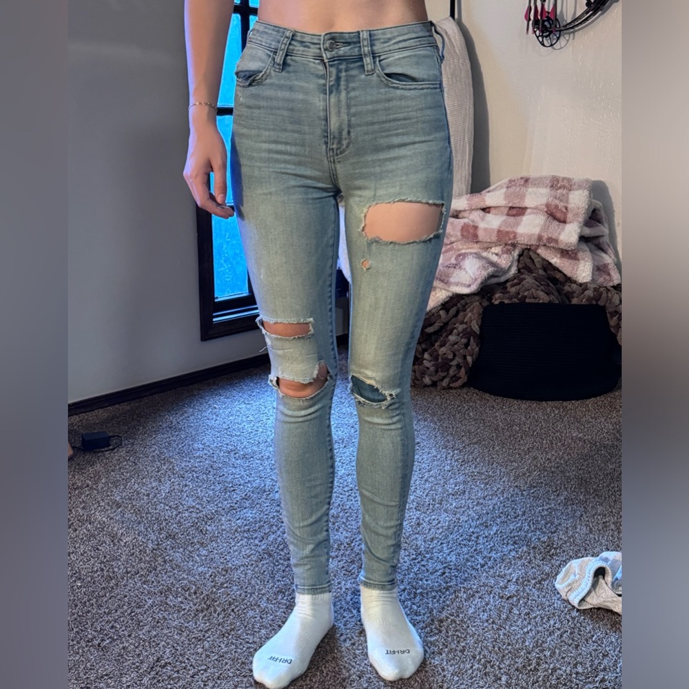 High rise jeans with holes and patches